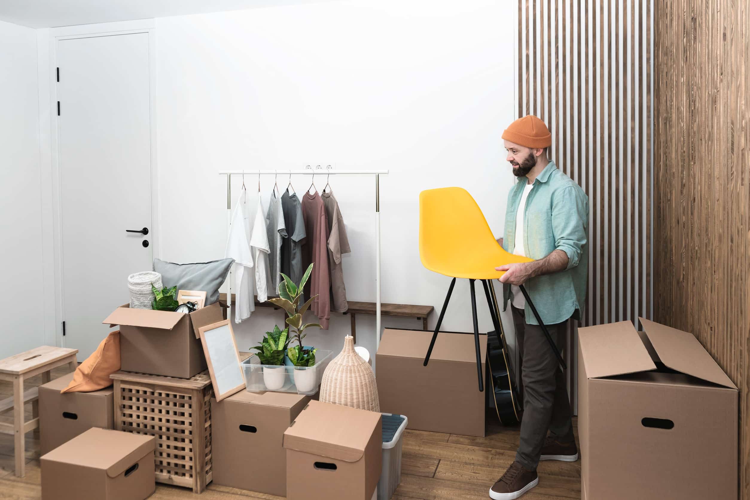Adult men unpacking boxes in new home on moving day