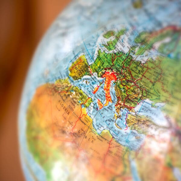 Italy colored in red on a world map – international relocation